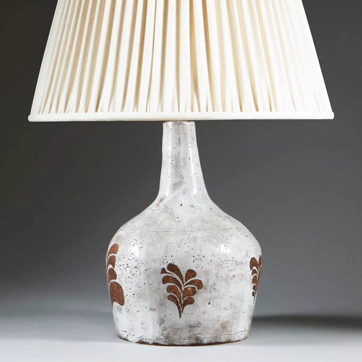 French Mid-Century Glazed Ceramic Table Lamp with white glaze and biscuit leaf motifs, 32 cm high, shade not included.