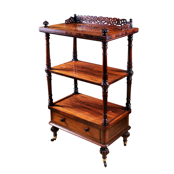 Victorian Rosewood Whatnot Etagere with three tiers, carved gallery top, drawer, turned legs, and brass castors circa 1850.