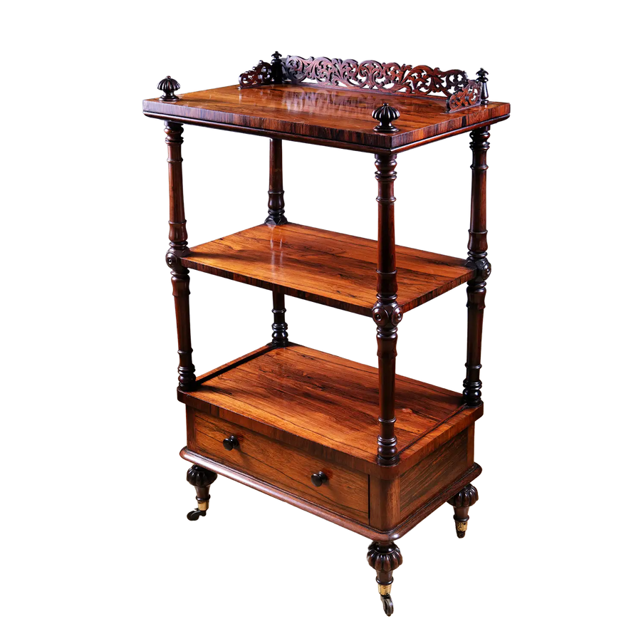 Victorian Rosewood Whatnot Etagere with three tiers, carved gallery top, drawer, turned legs, and brass castors circa 1850.