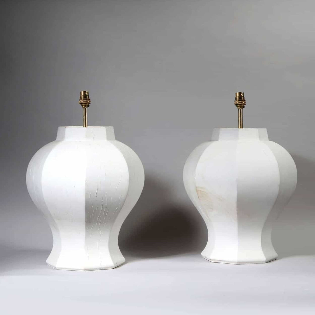 A Pair of Faceted Octagonal Wooden Lamps with white finish, circa 2000, height 43 cm, diameter 37 cm.