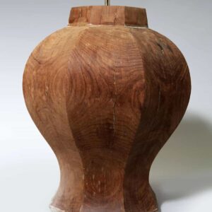 A close-up of a faceted octagonal wooden lamp base from a pair of Faceted Octagonal Wooden Lamps.