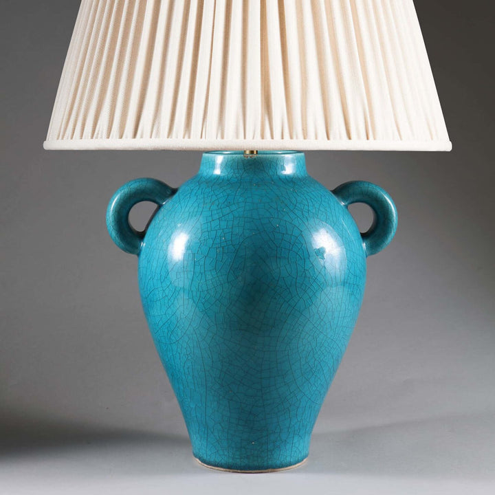Blue Crackle Glazed Vase by Signed Keramos Mounted as a Table Lamp with pleated cream lampshade on gray background