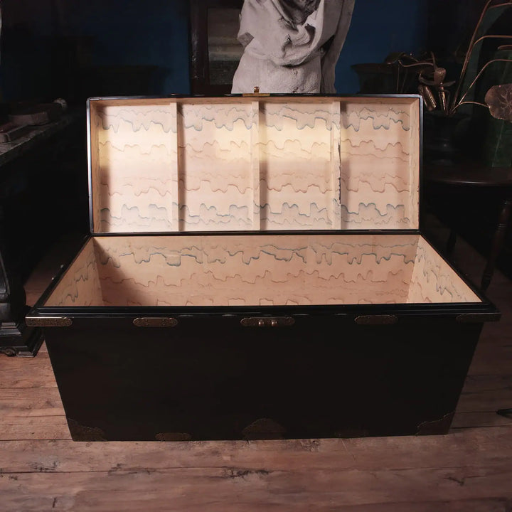 Edo Japanese Black Lacquer and Gilt Trunk with domed lid, brass mounts, and polychrome flame wallpaper interior.