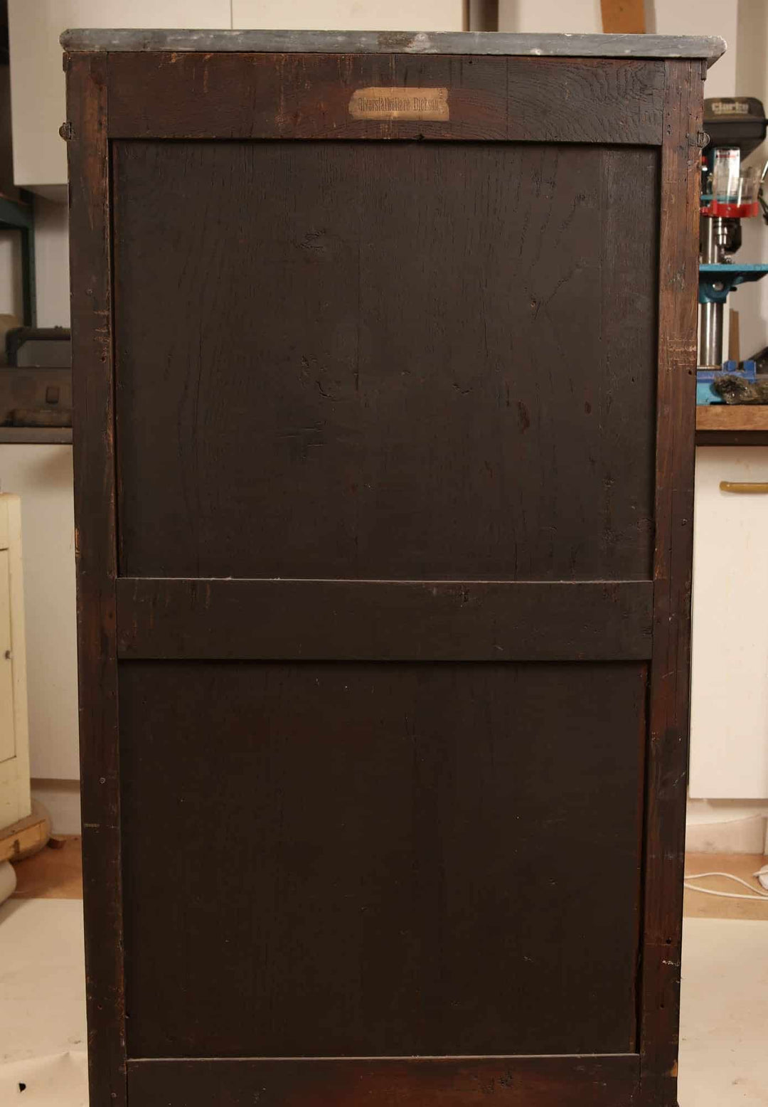 French Directoire Satinwood Secretaire Abattant showing its dark wood back panel in a workshop setting