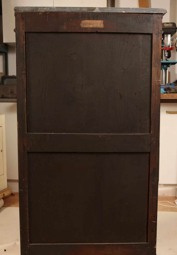 French Directoire Satinwood Secretaire Abattant showing its dark wood back panel in a workshop setting