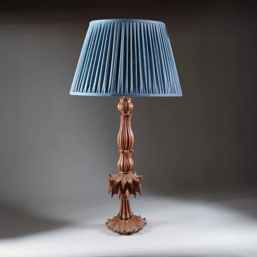 Futuristic Carved Teak Table Lamp with reeded stem, petal base, and blue pleated shade, 19th century Indian design.