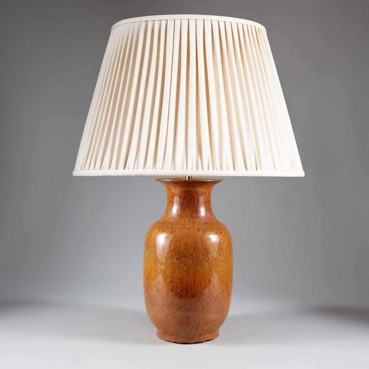 Monochrome Brown Glazed Lamp with a smooth brown ceramic base and pleated cream fabric shade, 33 cm tall.