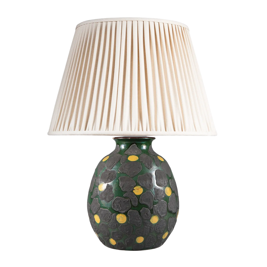 Green Glazed Lamp with Charcoal Dots and Yellow Accents with pleated white lampshade and textured base design.