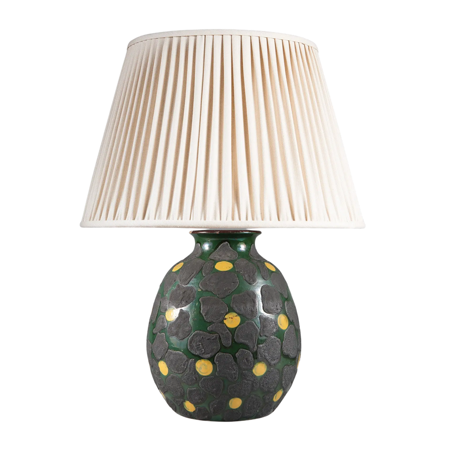 Green Glazed Lamp with Charcoal Dots and Yellow Accents with pleated white lampshade and textured base design.