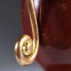 Faux Porphyry Baluster Lamps by Andrew Allfree with red faux porphyry and gold leaf scroll arms close-up detail.