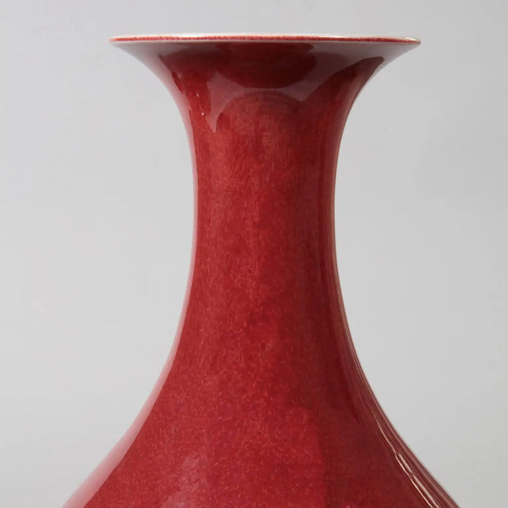 Pair of Meiping Sang de Boeuf Table Lamps with deep red porcelain glaze and elegant bottle vase shape.