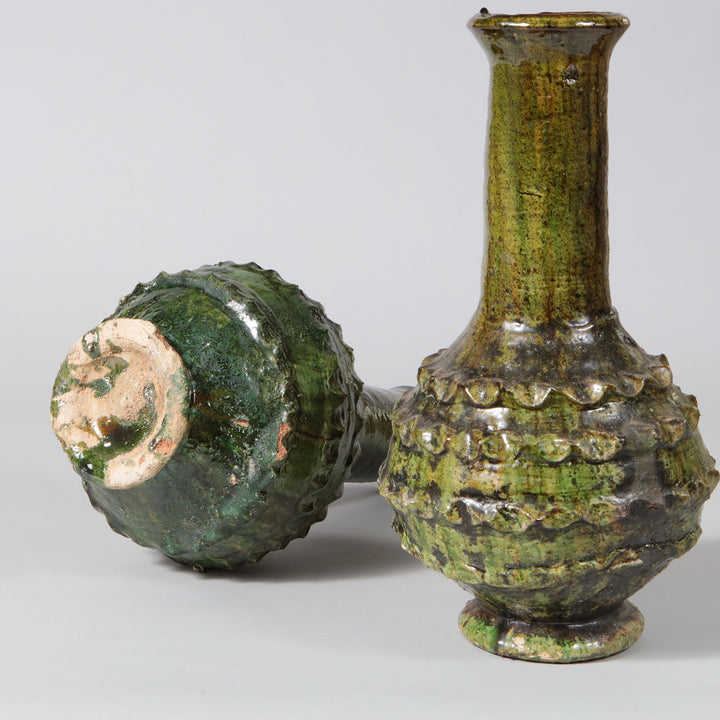 Pair of Green Glazed Bottle Vases as Table Lamps with tall pottery bases and incised decorative patterns.