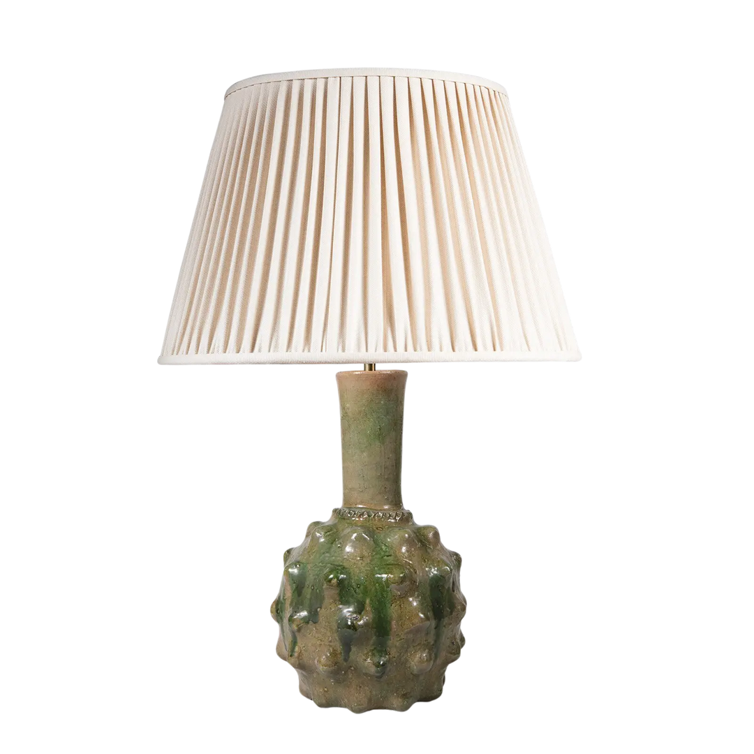Spiked Green bottle Vase as a Table Lamp with textured spiked ceramic base and cream pleated lampshade on a transparent background