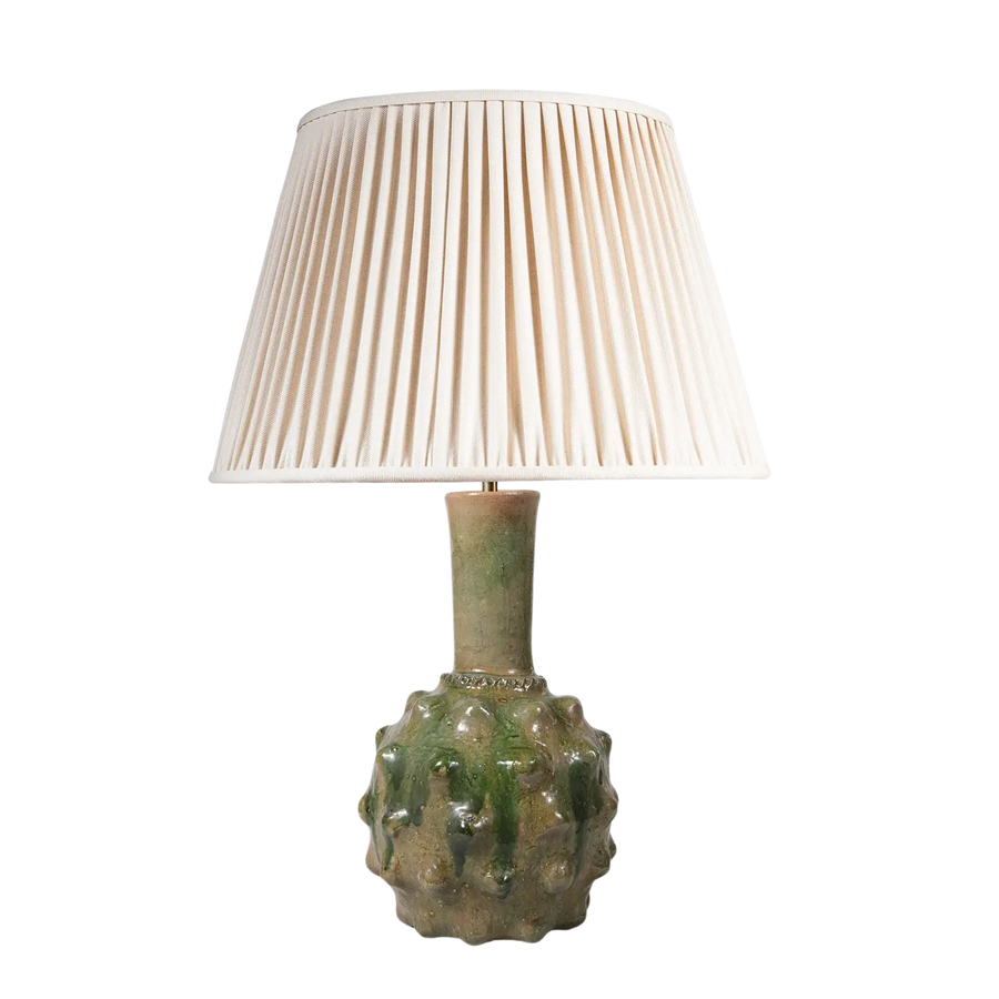 Spiked Green bottle Vase as a Table Lamp with textured spiked ceramic base and cream pleated lampshade on a transparent background