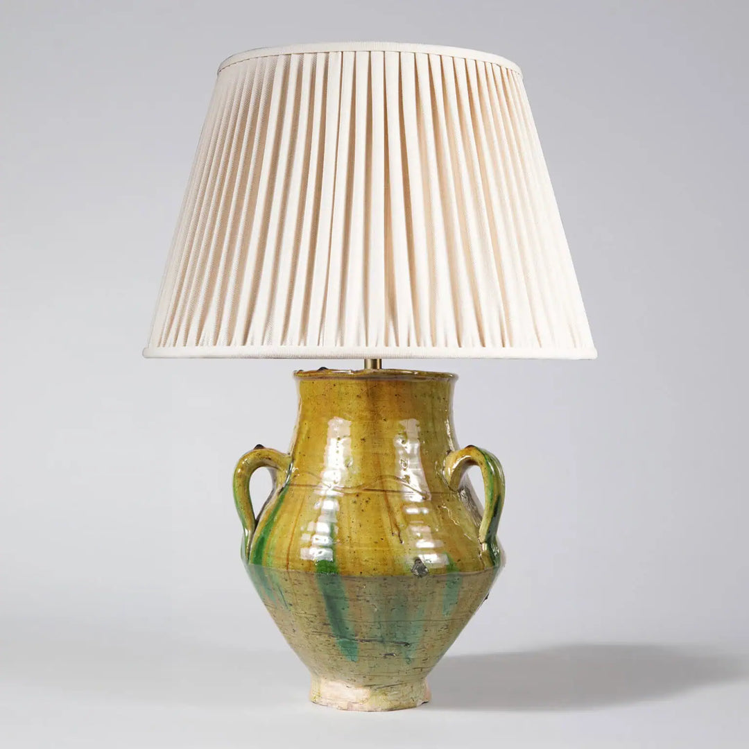 Green Glazed Yellow Green Ribbed Jar as a Table Lamp with three handles and cream pleated lampshade.
