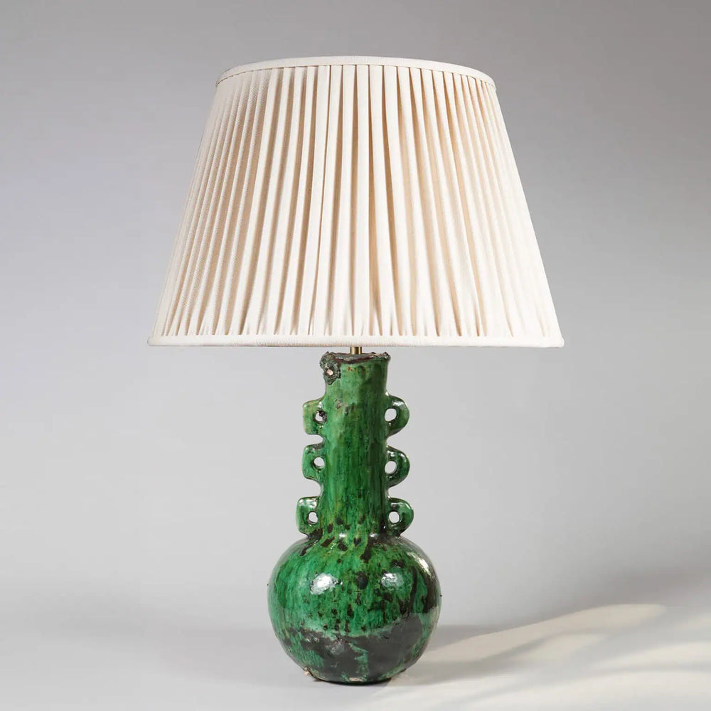 Green Glazed Pottery Bottle Vase as a Table Lamp with cream pleated shade and textured glossy green ceramic base