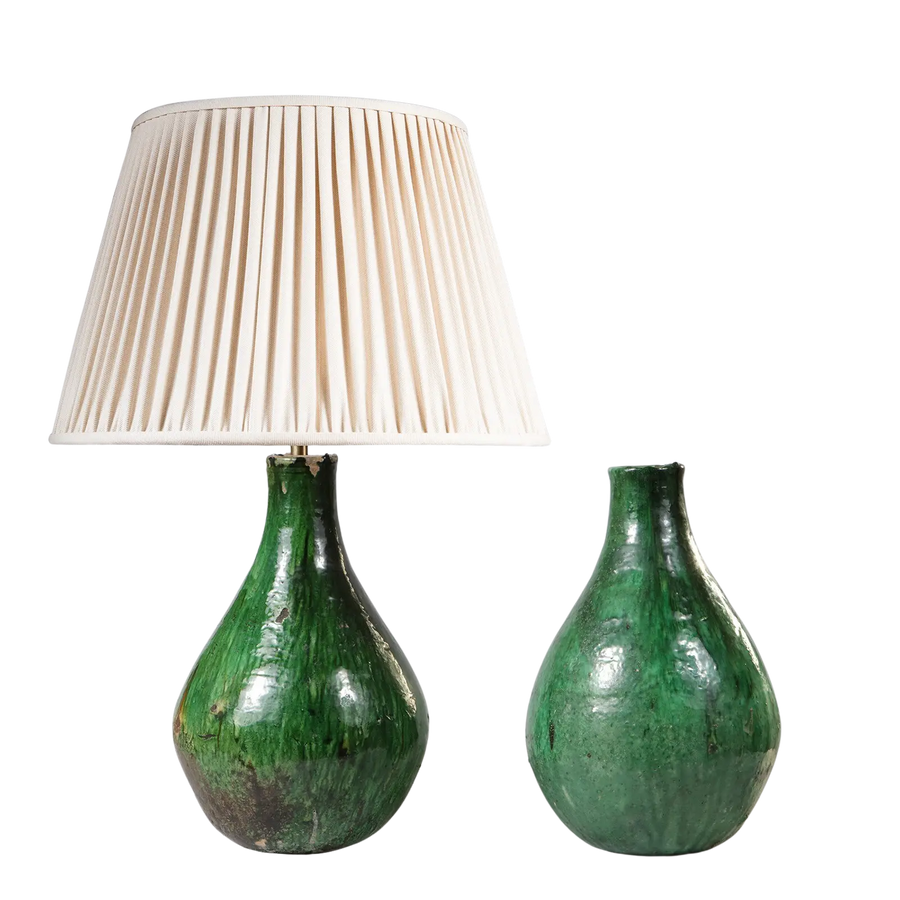 Pair of Green Glazed Pottery Vases as Table Lamps with one lamp featuring a cream pleated shade and the other vase only.
