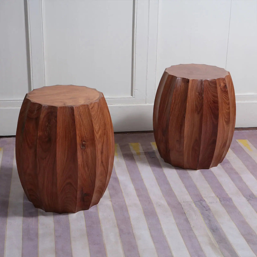 Pair of Fluted Wooden Barrel End Tables with 56 cm height and 38 cm top diameter on striped floor against white wall