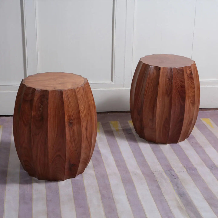 Pair of Fluted Wooden Barrel End Tables with 56 cm height and 38 cm top diameter on striped floor against white wall