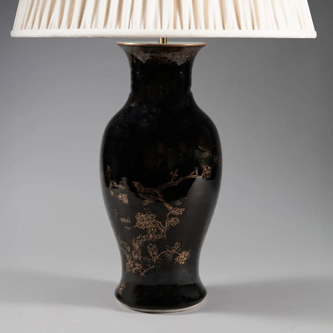 A Chinese Export Black Glazed and Gilt Table Lamp with 18th-century black glaze and gilt bird and blossom design.