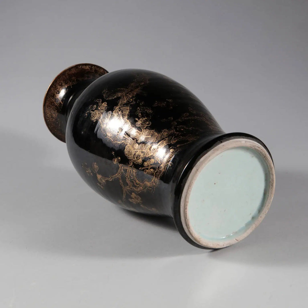A Chinese Export Black Glazed and Gilt Table Lamp with 18th century black glaze and gilt rocky scenery details.