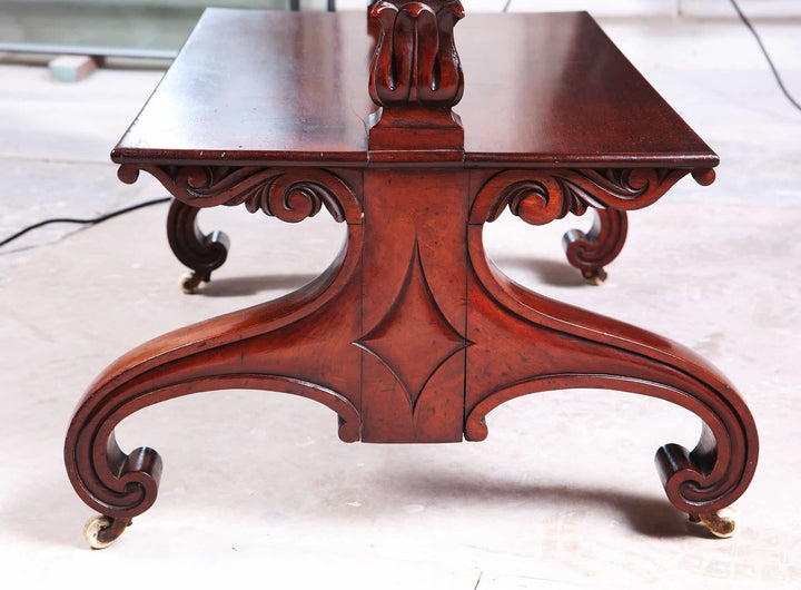 William IV Mahogany Etagere with carved details on curved legs and brass casters, mid-19th-century English design