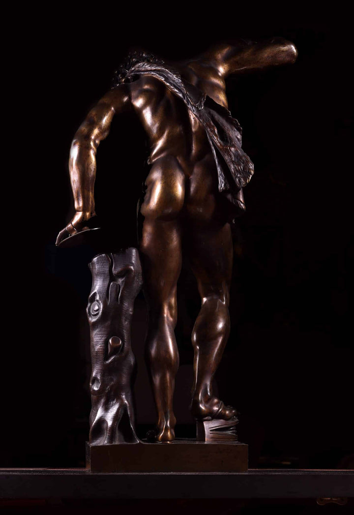 Bacchanalian Bronze Faun After Soldani antique bronze sculpture of a faun with wood-textured support base.