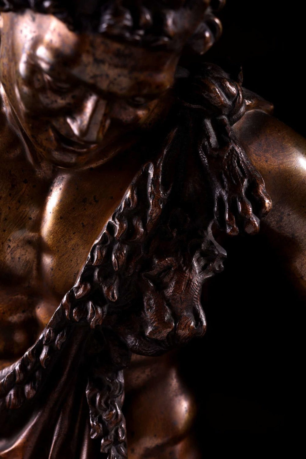 Bacchanalian Bronze Faun After Soldani antique bronze sculpture showing detailed upper torso and drapery close-up.
