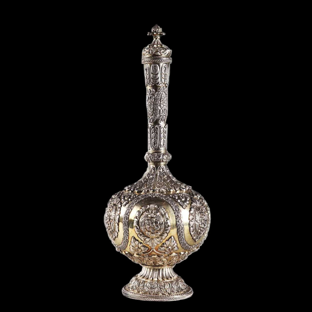 Decorative Indian silver flask with raised intricate patterns on a gilt ground.