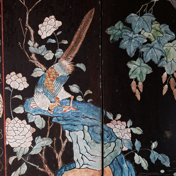 An early 19th century four fold Chinese lacquer screen