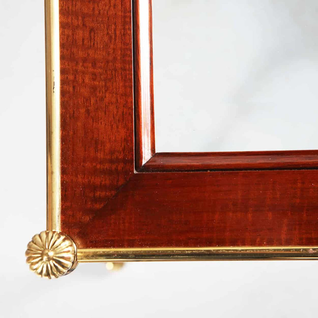 Pair of Mallett End Tables with hand bevelled glass tops, fiddle back mahogany borders, and polished brass legs.