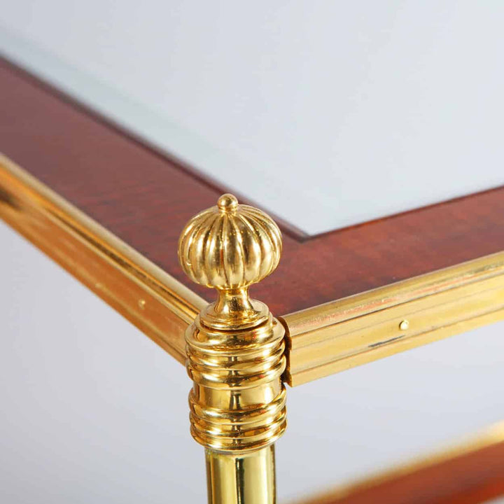Pair of Mallett End Tables with hand bevelled glass tops, fiddle back mahogany borders, and polished brass legs.