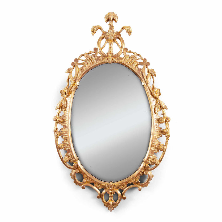 George III Rococo giltwood oval mirror with ornate floral and scroll detailing, English, circa 1770, 81 cm height.
