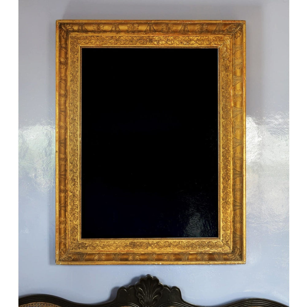 19th Century Rectangular French Empire Gilt Frame Mirror with ornate anthemions, lyres, and oak leaf details.