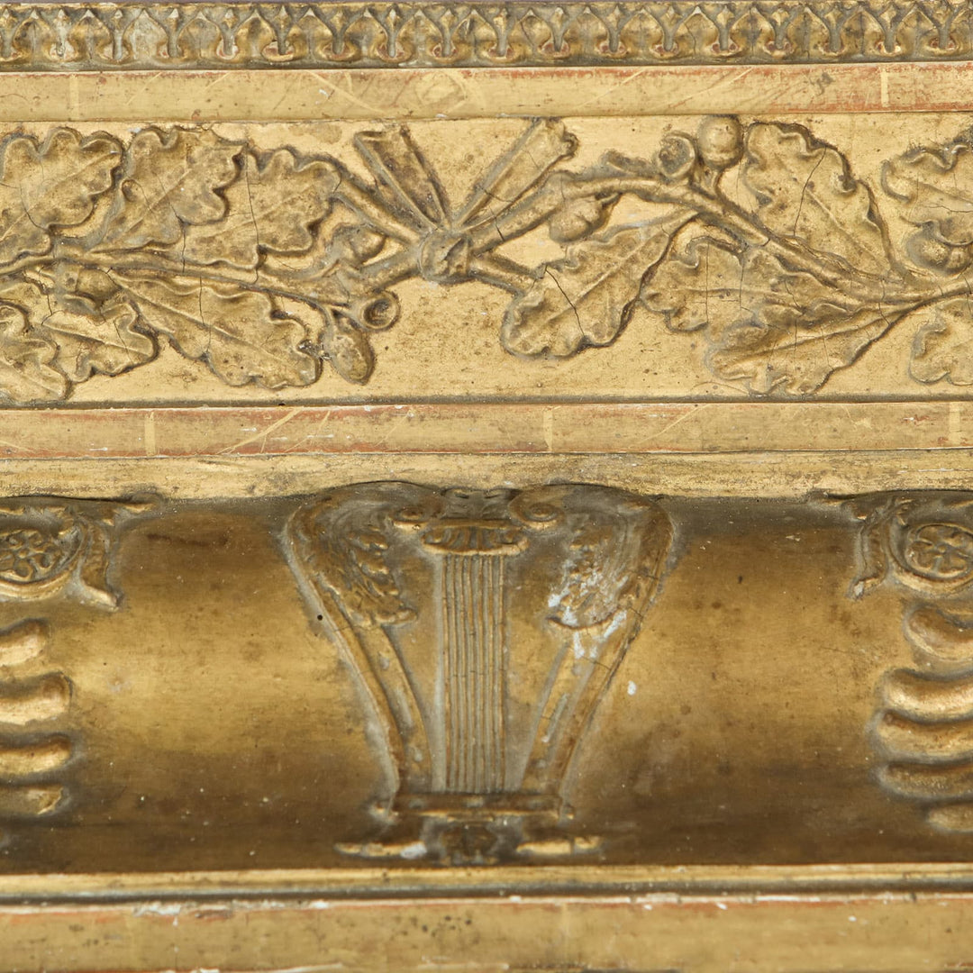 19th Century Rectangular French Empire Gilt Frame Mirror with detailed anthemions, lyres, and oak leaf carvings.