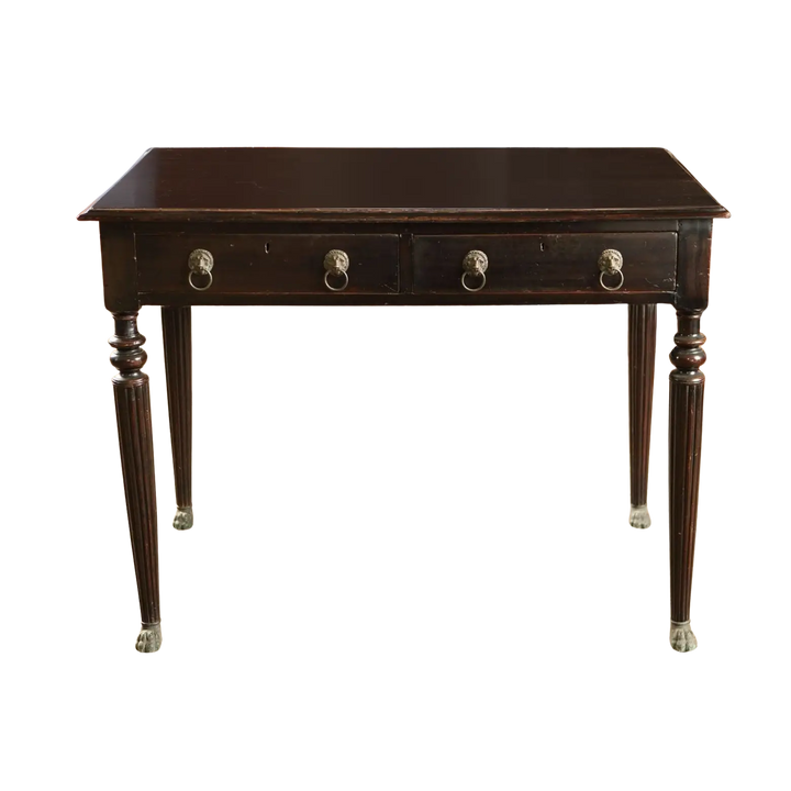 Anglo Indian Ebonised Writing Table with two drawers, fluted legs, lion mask handles, and brass paw feet from 1860.