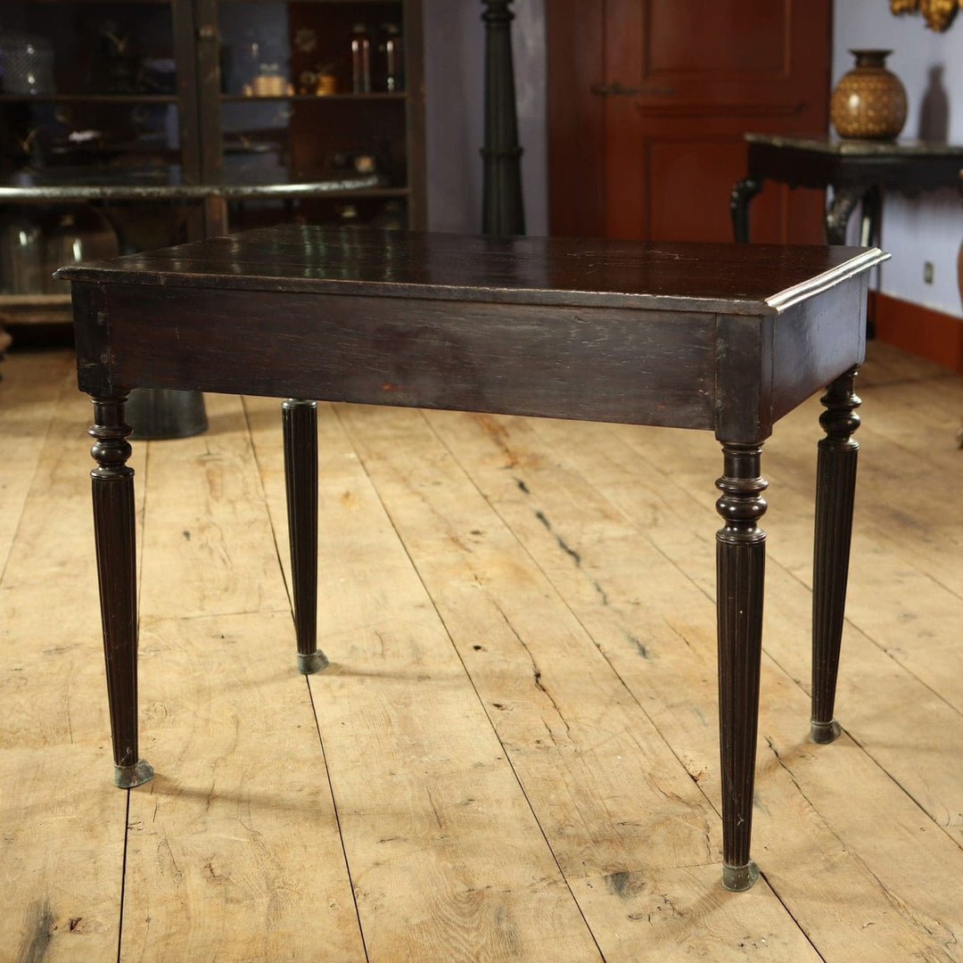 Anglo Indian Ebonised Writing Table with two drawers, lion mask handles, fluted legs, and brass paw feet circa 1860.