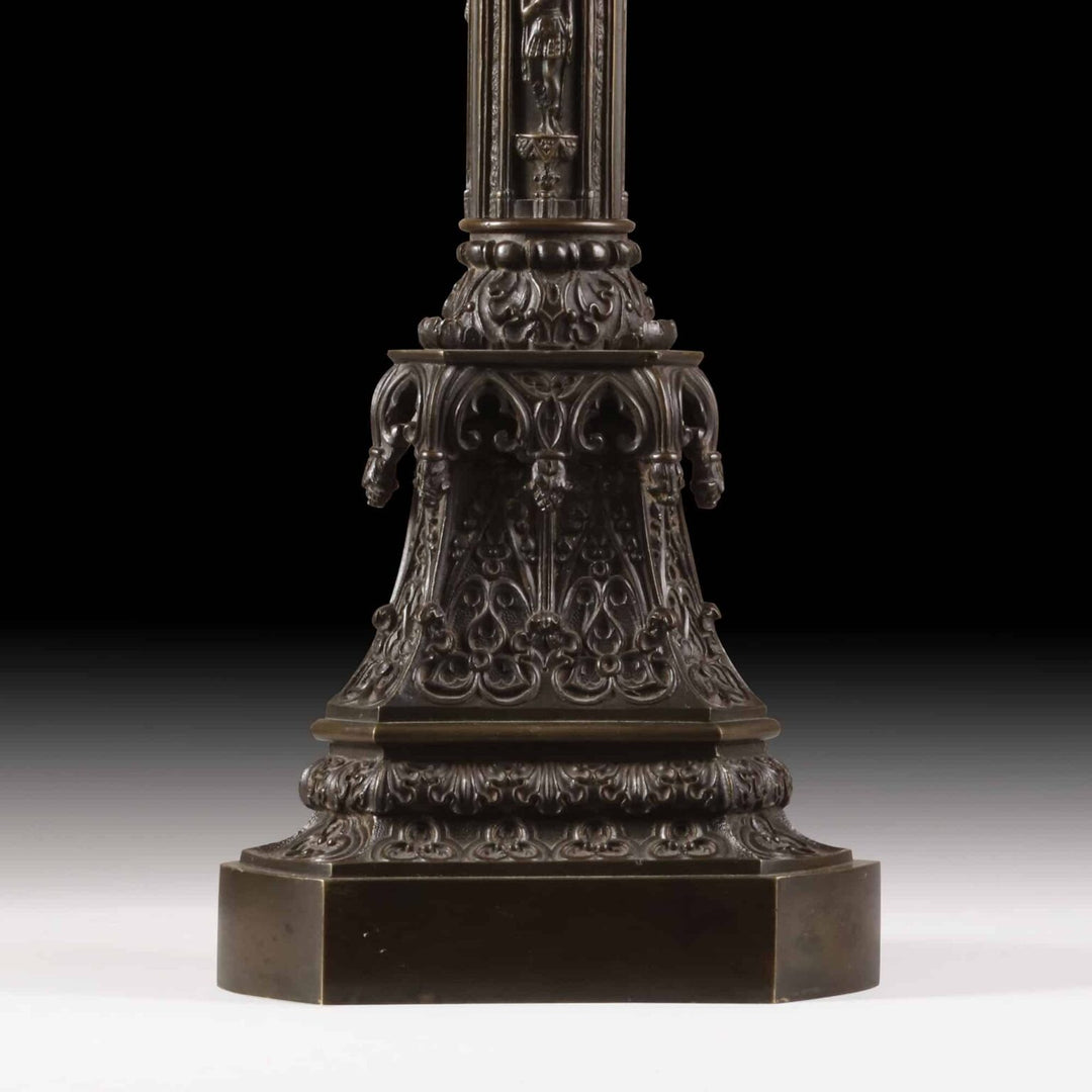 A William IV bronze gothic column lamp base with intricate medieval-style figures and decorative crown capital circa 1840.