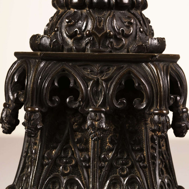 A William IV bronze gothic column lamp with intricate medieval-style figures and decorative gothic niches.