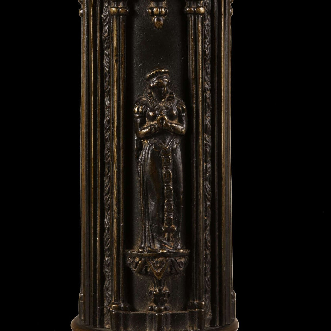 A William IV bronze gothic column lamp with medieval-style figures in low relief on a richly decorated column.