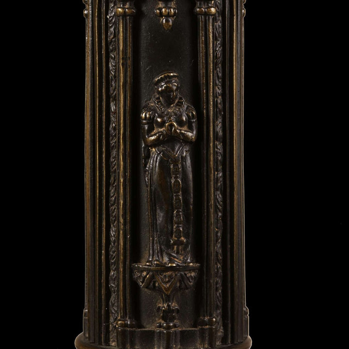 A William IV bronze gothic column lamp with medieval-style figures in low relief on a richly decorated column.