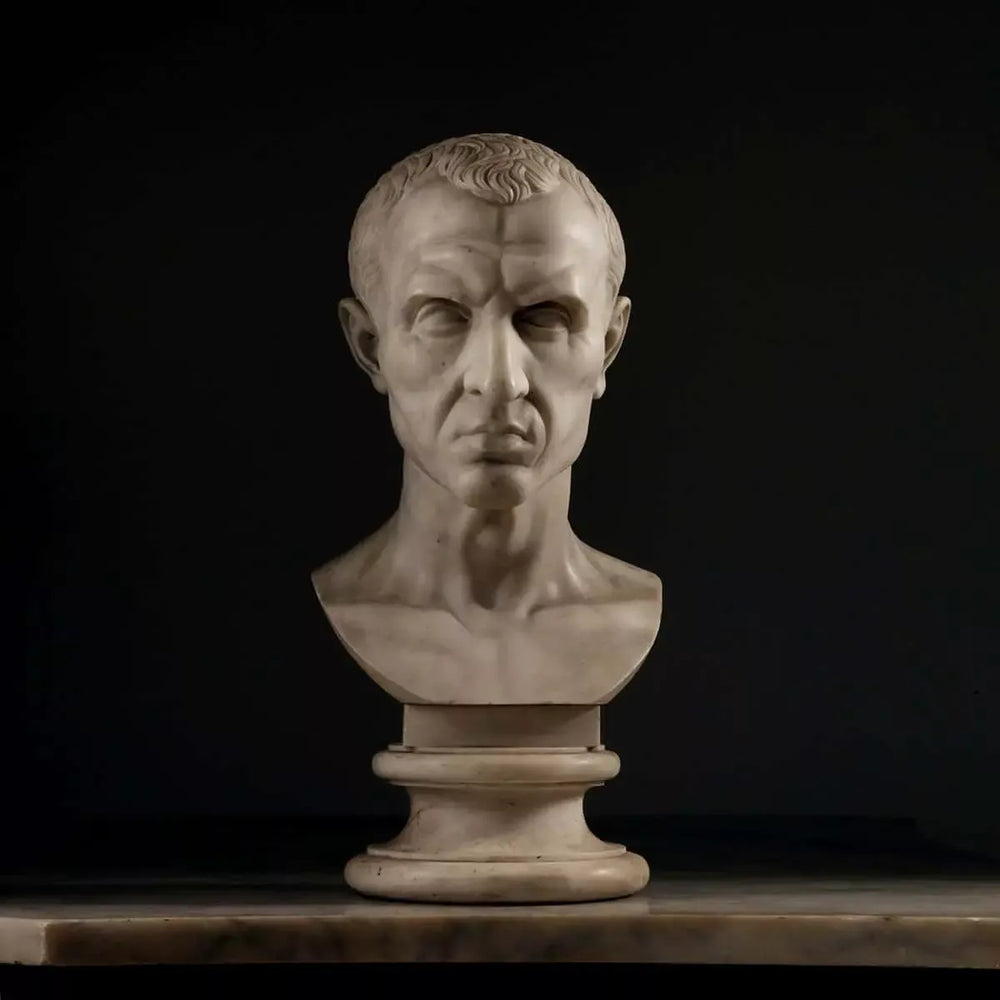 19th Century Grand Tour Bust of Julius Caesar marble portrait sculpture on pedestal against black background