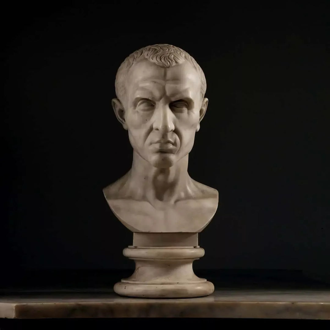 19th Century Grand Tour Bust of Julius Caesar marble portrait sculpture on pedestal against black background