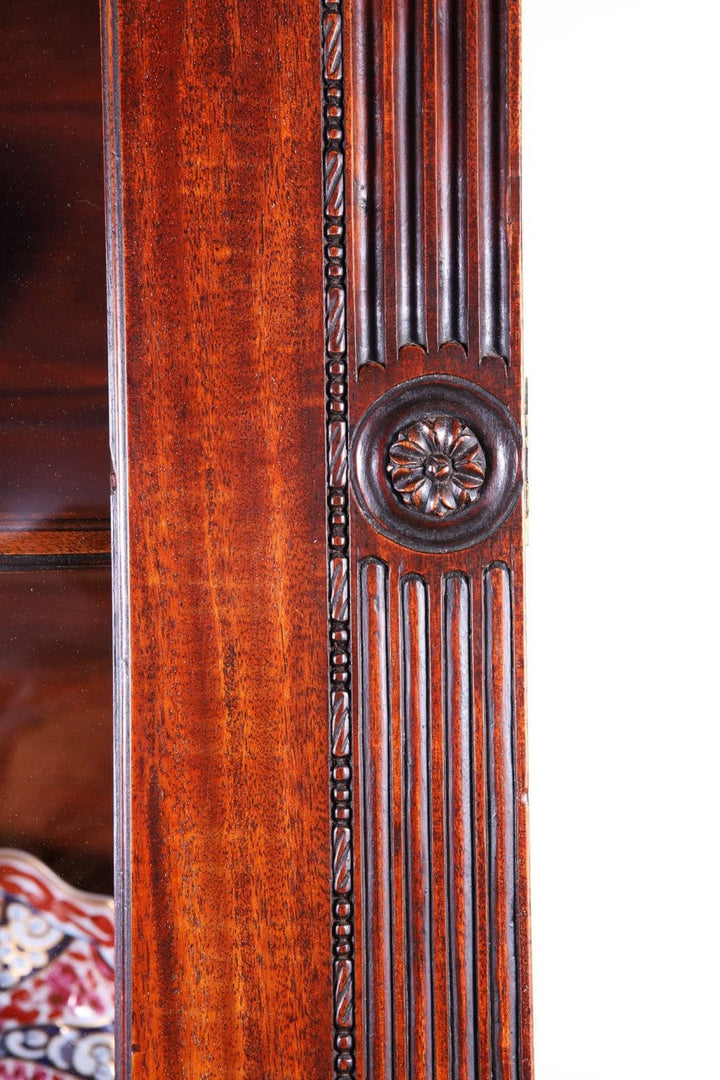 George III Chippendale period mahogany breakfront bookcase detailed carved fluted pilaster close-up.