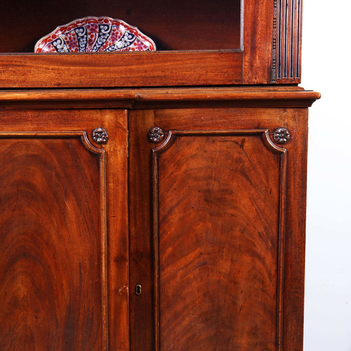 George III Chippendale period mahogany breakfront bookcase with carved detailing and glazed doors.