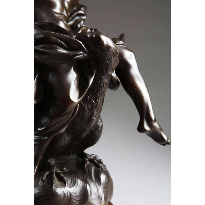 Antique Bronze Statue of Zeus riding an Eagle showing detailed eagle claws and part of Zeus's leg on bronze base