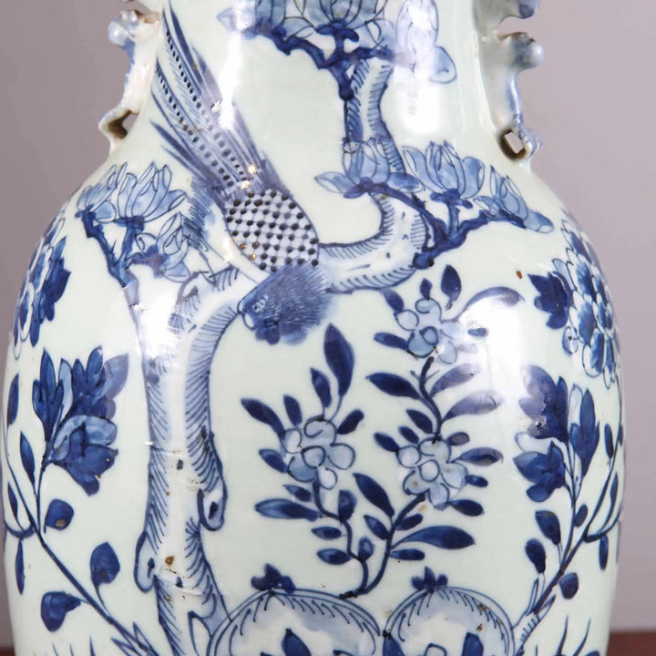 Chinese Blue and white table lamps with intricate bird and floral designs on porcelain vases mounted on wooden bases