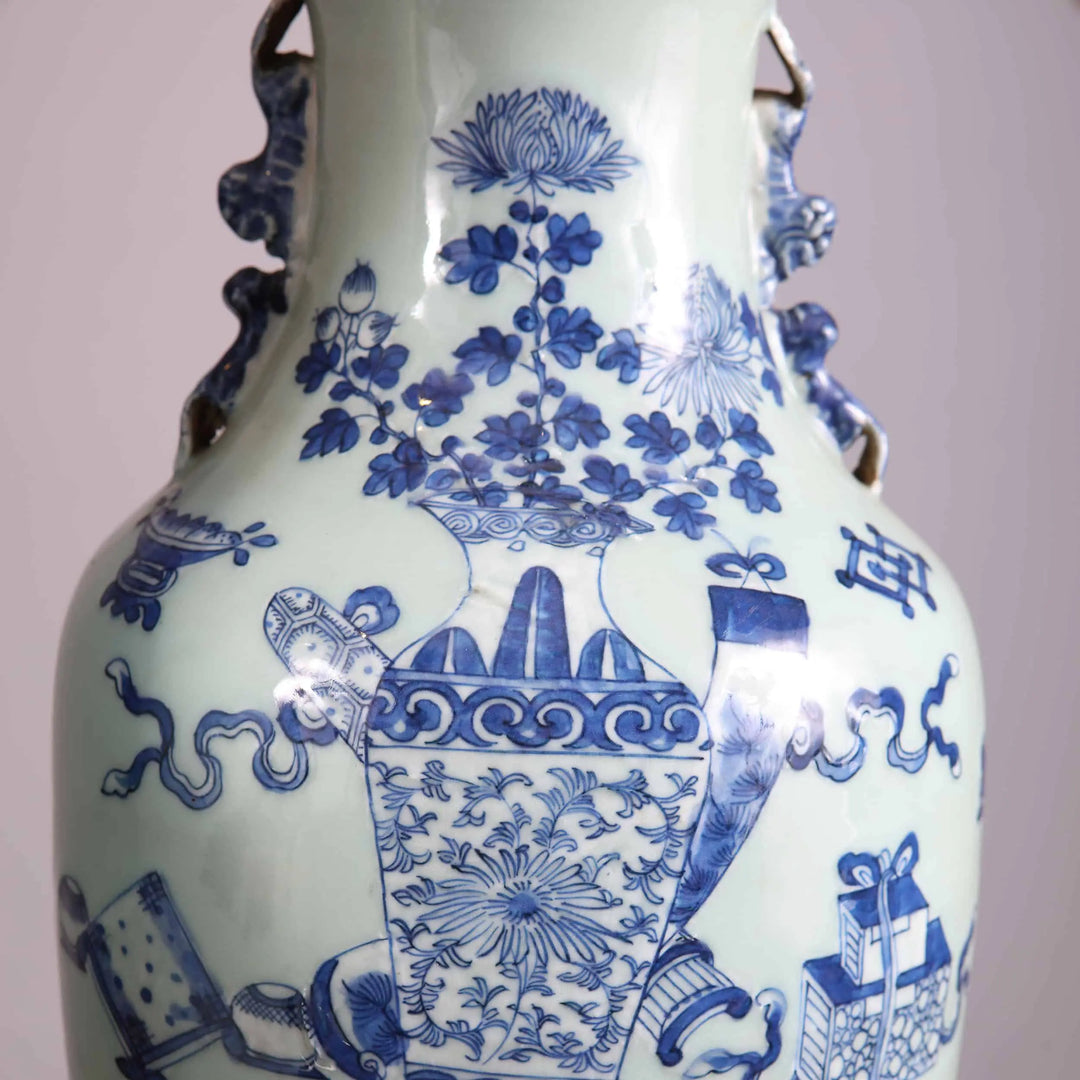 Chinese Blue and white table lamps featuring detailed floral and object scenes on porcelain vases with wooden bases and brass caps.