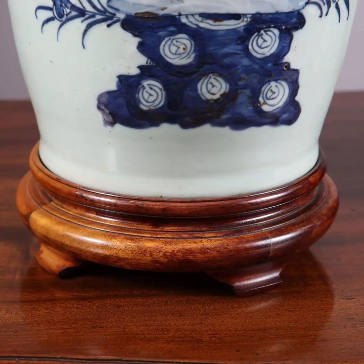 Chinese Blue and white table lamps with bird and foliage design on wooden bases and brass caps.