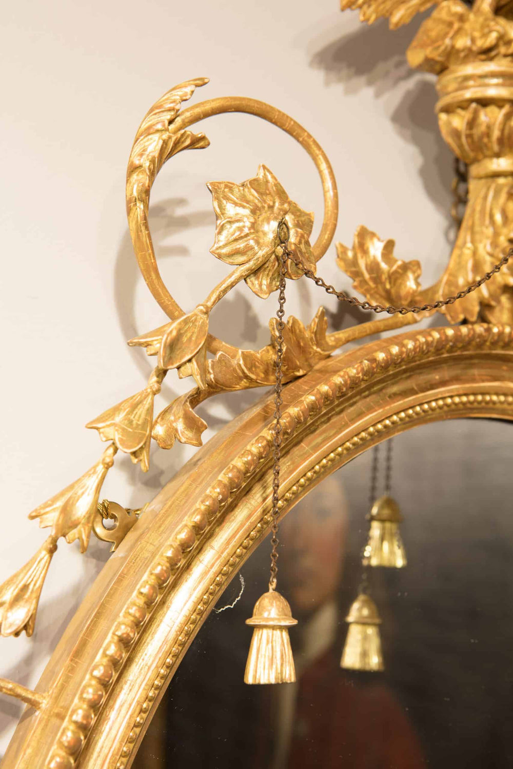 Pair of George III Giltwood Oval Mirrors with neo-classical eagle and harebell details and gilt tassels, circa 1770.